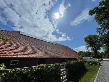 Een groot dak van een boerderij schoonmaken
